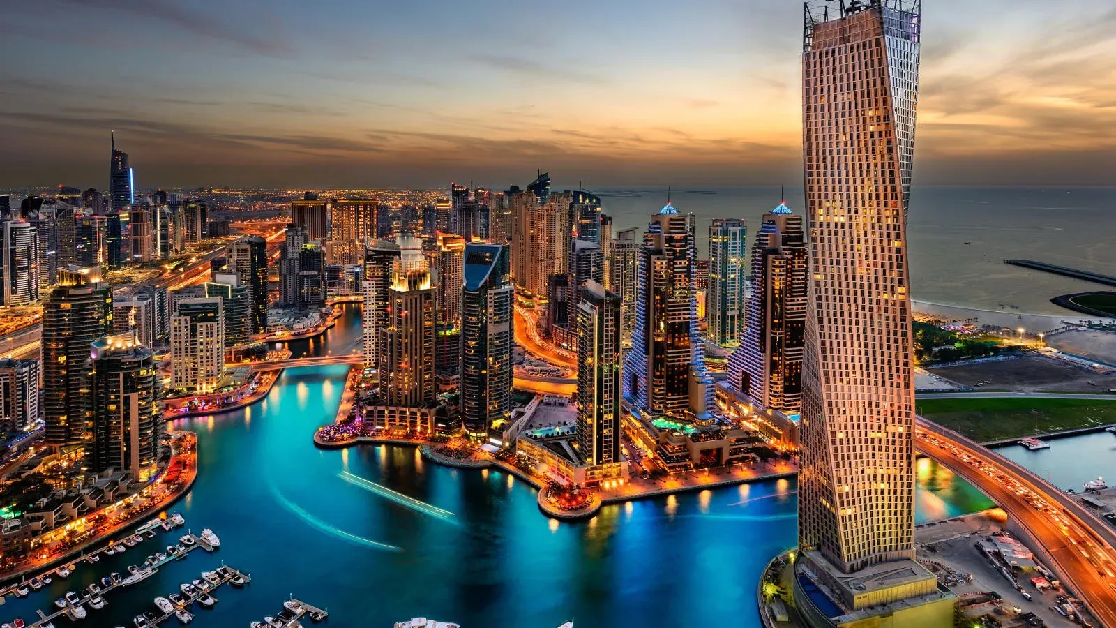 Dubai Marina waterfront and illuminated towers at dusk